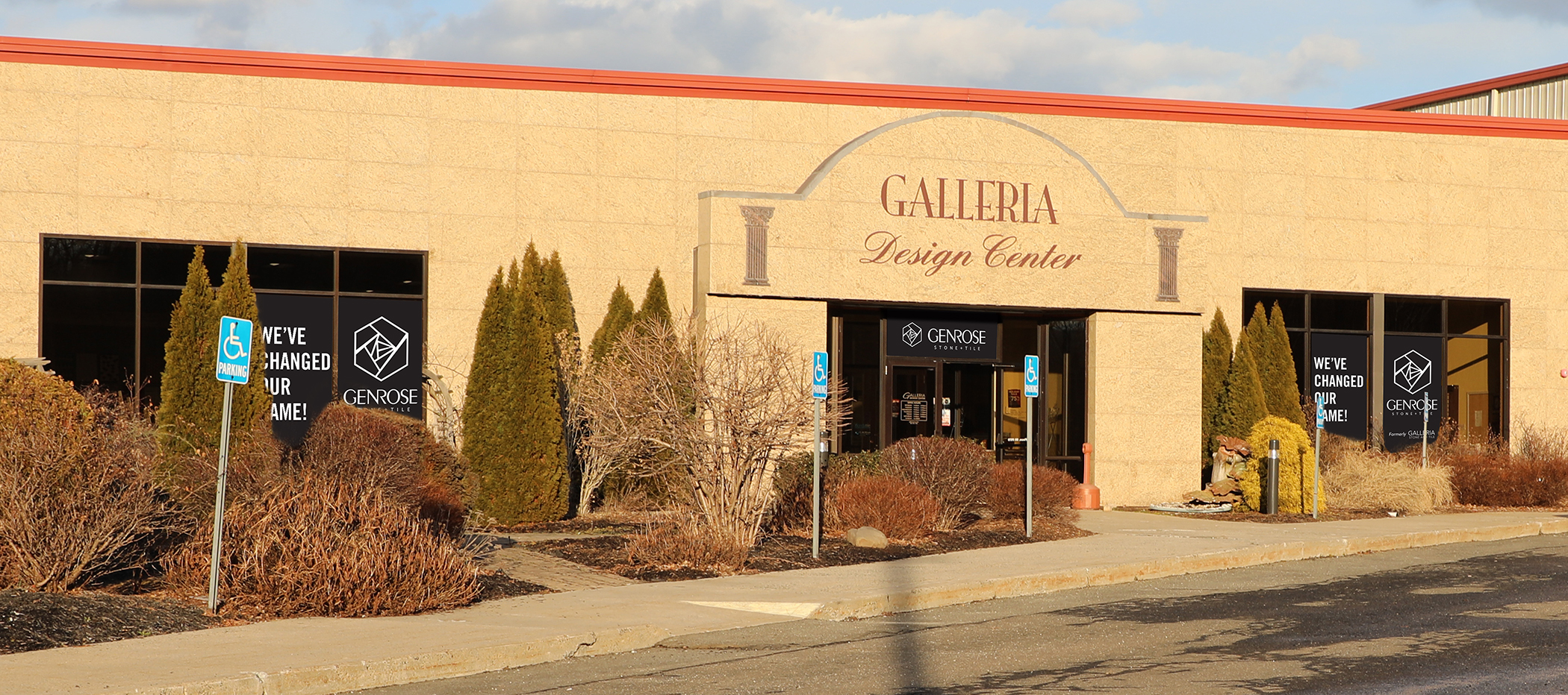 Exterior of Galleria Design Center with beige stone facade and large windows displaying We've Changed Our Name signs.