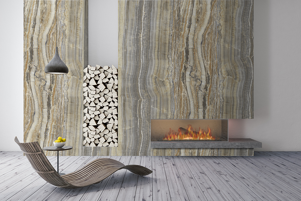 Modern fireplace with gray and beige onyx stone panels, a stack of firewood, and a sleek wooden chair.
