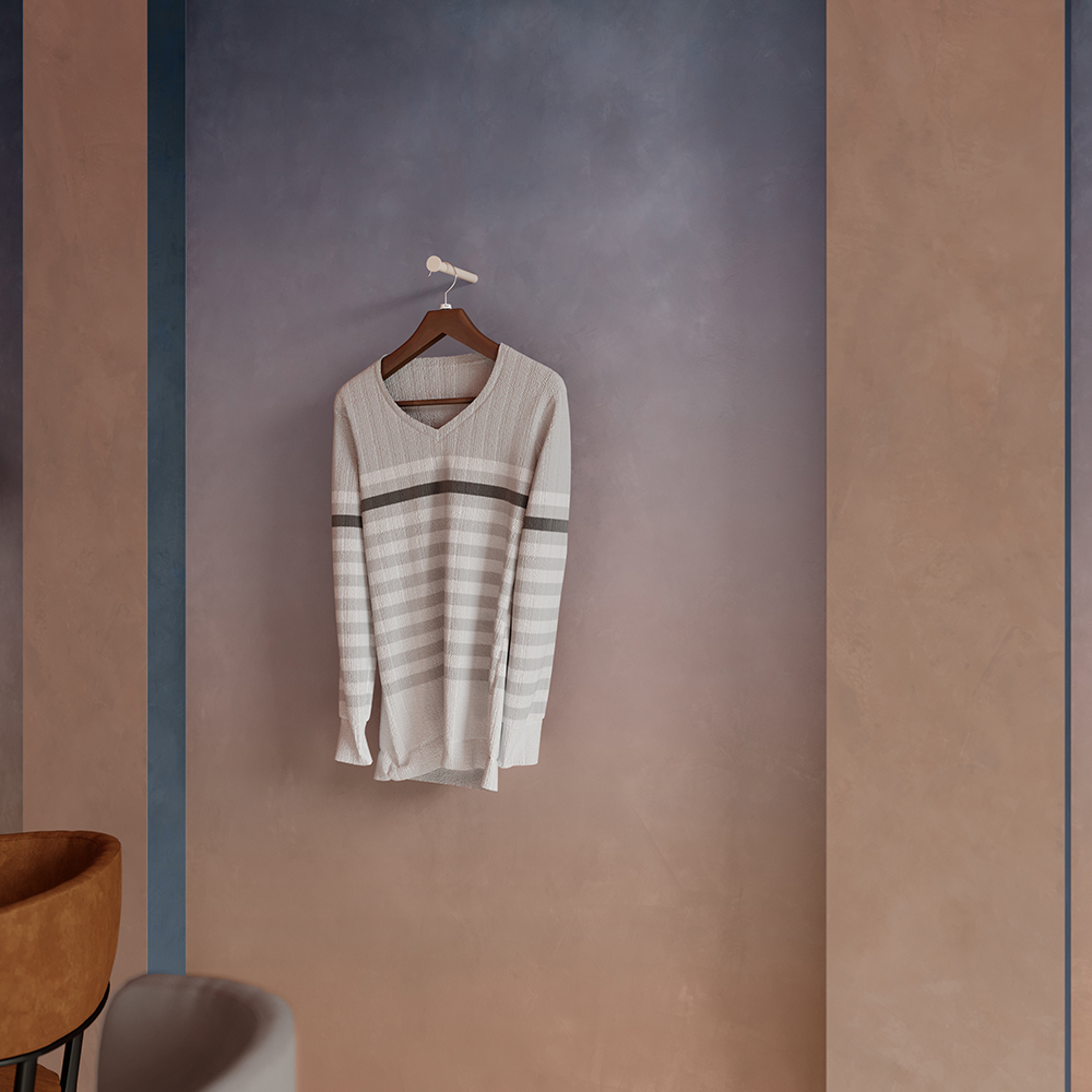 Beige and gray striped sweater hanging on a wall with Spirit Porcelain Tile in Spice color.