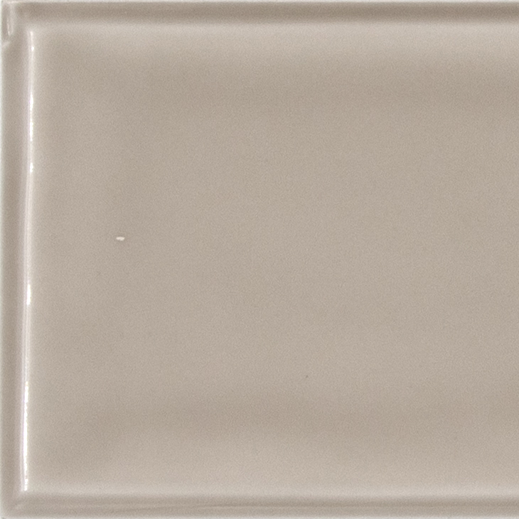 Glossy beige ceramic wall tile.