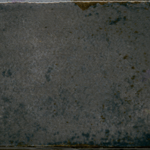 Glossy dark gray ceramic tile with subtle texture.