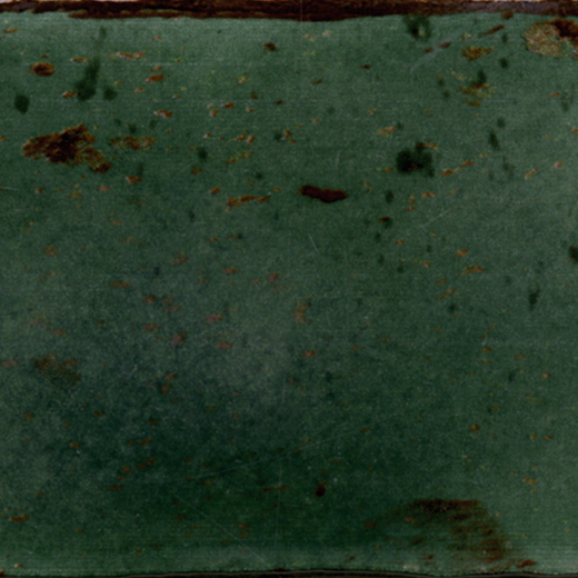 Glossy jade green ceramic tile with subtle speckles.
